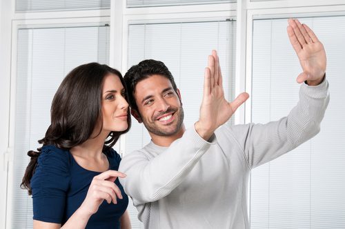 Couple is imagining where they are going to put the pictures in the new house.