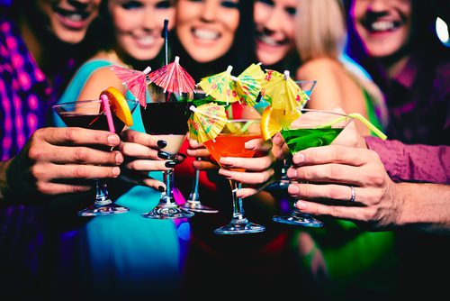 Group of women giving cheers with fancy cocktails