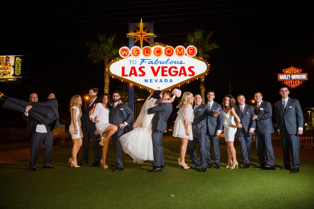 Wedding Party standing inside of the Welcome to Las Vegas sign