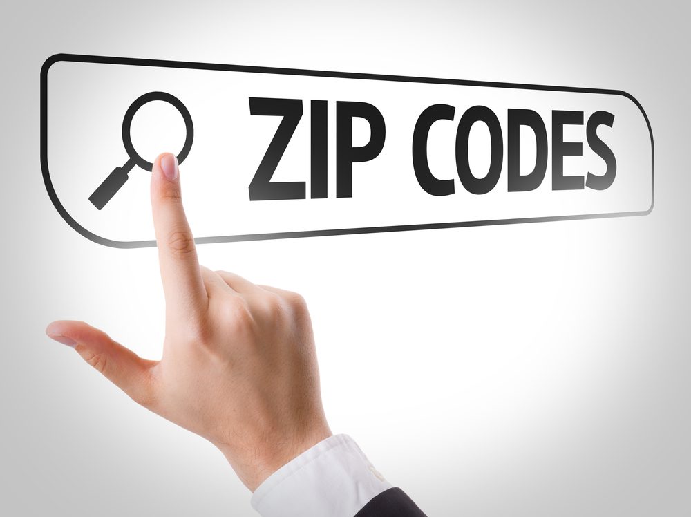 Man has his finger pointing to a computer search with the words Zip Codes in the search bar