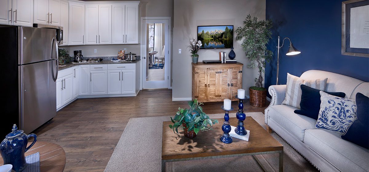 Beautiful open floorplan of the Ashmore next gen home with in-law quarters by Lennar in Southwest Las Vegas. White cupboards, hardwood floors, blue accents