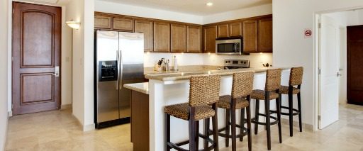 kitchen with chairs at bar and view of kitchen door