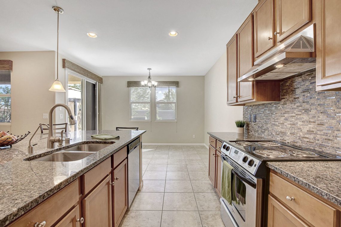 Located in the highly desirable area near Aliante close to parks, shopping & dining! Home features a large open kitchen with a huge island and all stainless steel appliances. 
